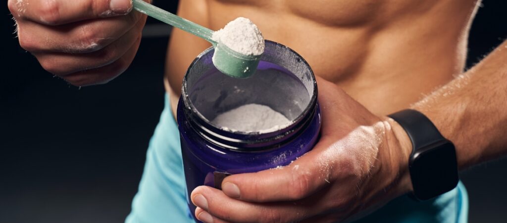 man scooping preworkout powder