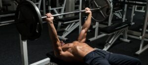man bench pressing barbell