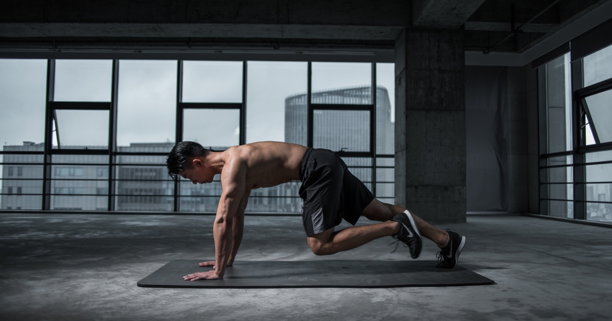 physically fit man doing exercises on the floor