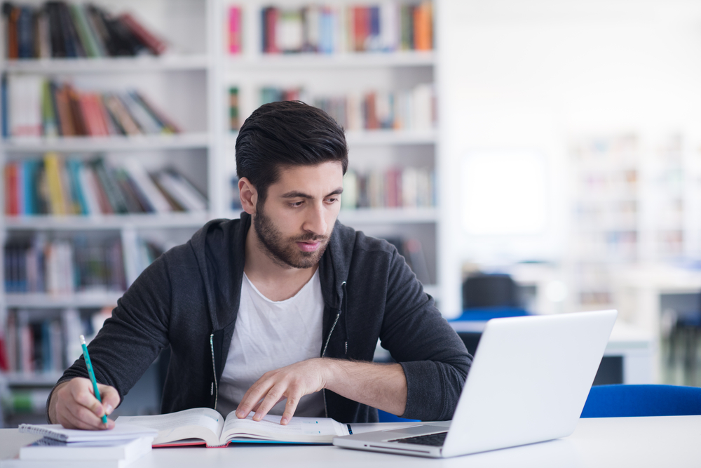 man learning and studying for an exam