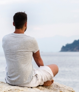 man praying and meditating in nature