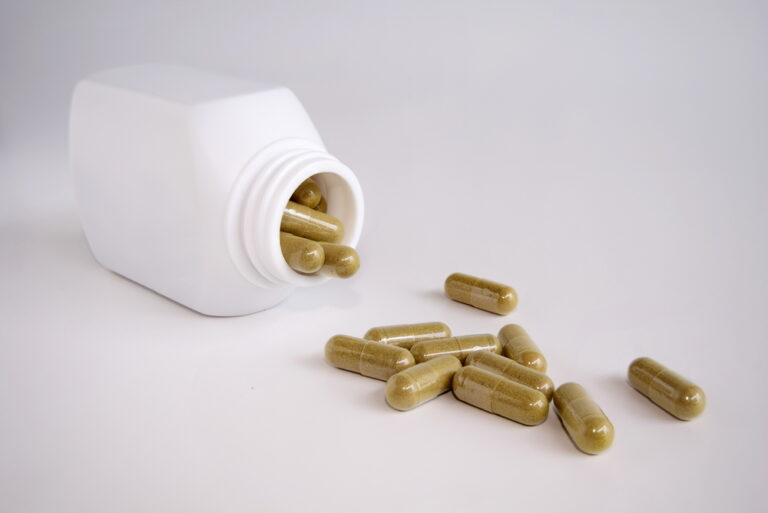 ashwagandha capsules spilling out of bottle