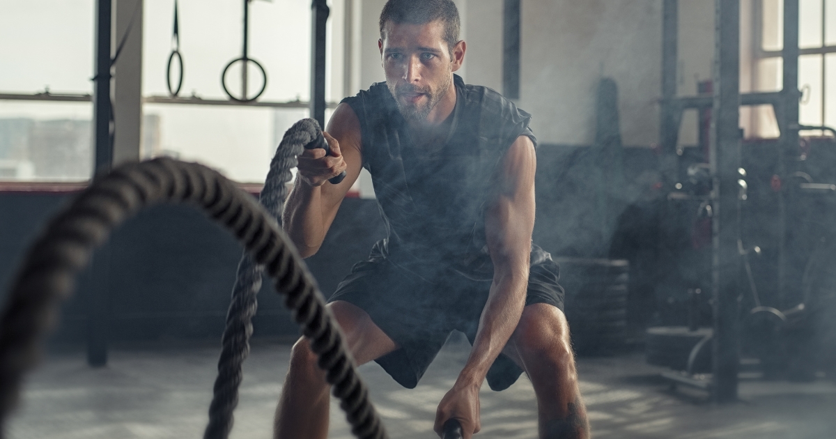 man doing battle rope exercise