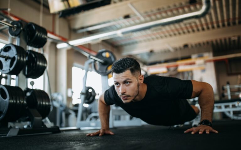 man doing pushups on gym floor